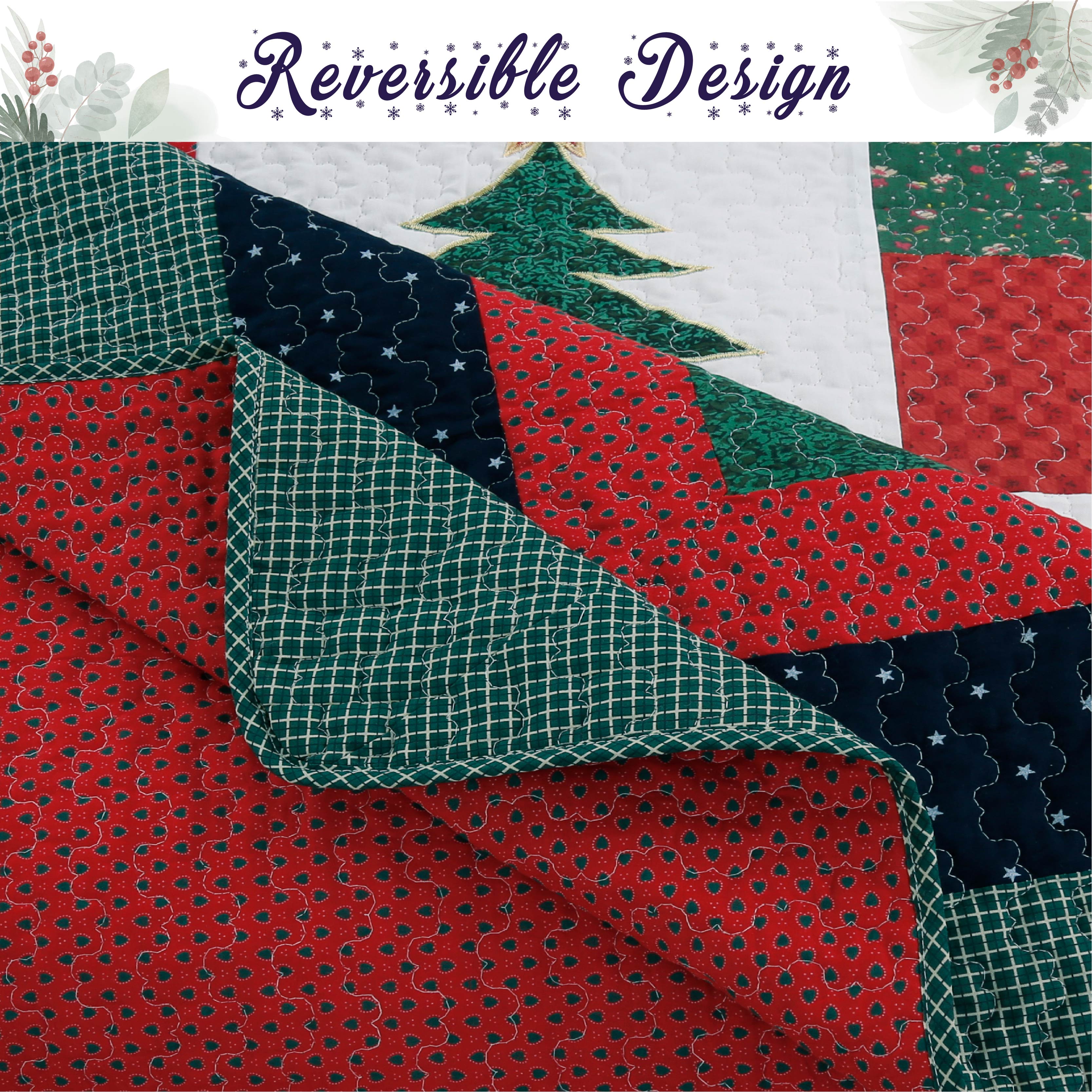 A close-up of a quilted fabric design with red, green, and navy sections, including a Christmas tree motif and floral patterns. A banner at the top reads 'Reversible Design' with a small floral border.