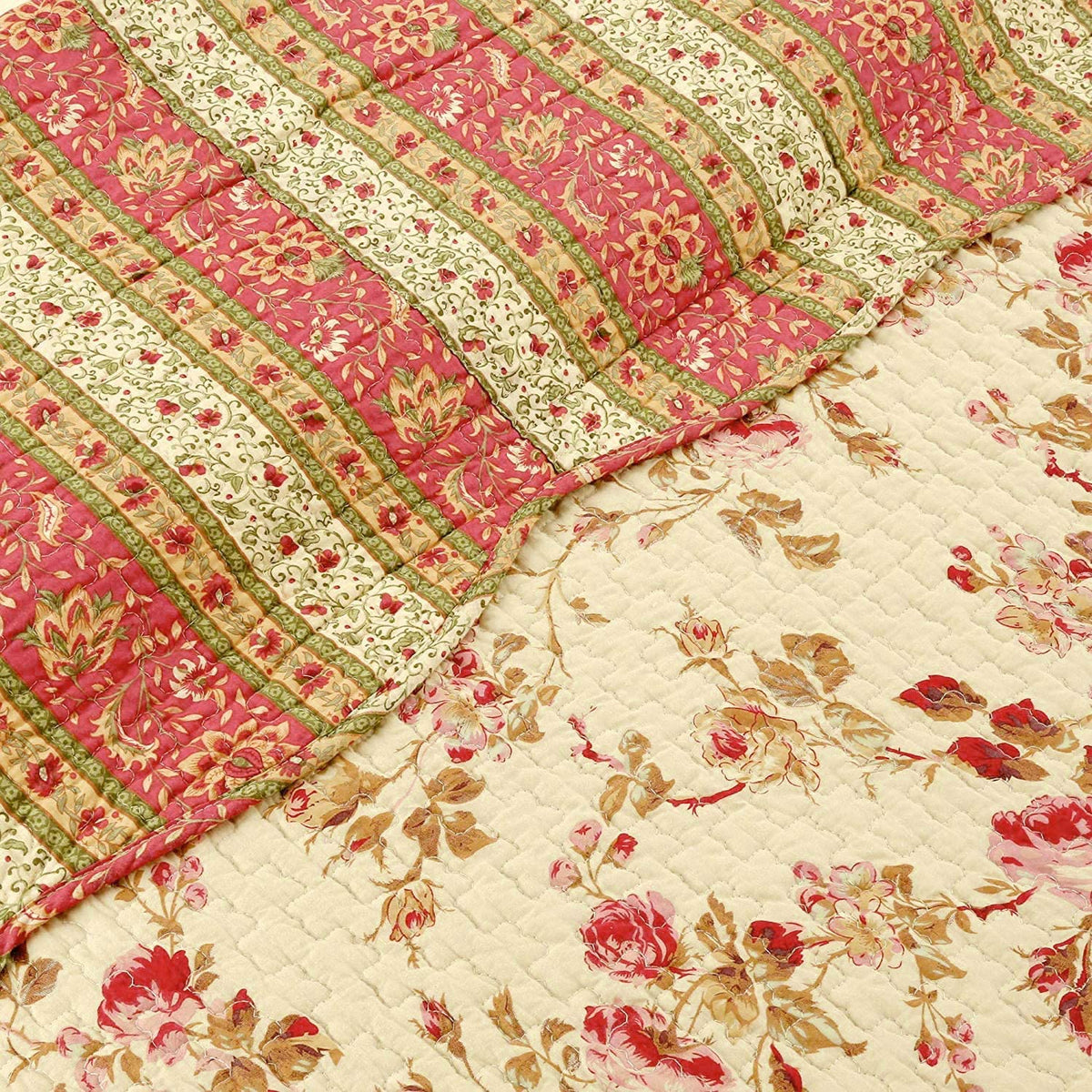A close-up of a quilted fabric with a floral and striped pattern, showing two overlapping sections: one in pink and green with floral motifs, and one in cream with red and green floral prints.