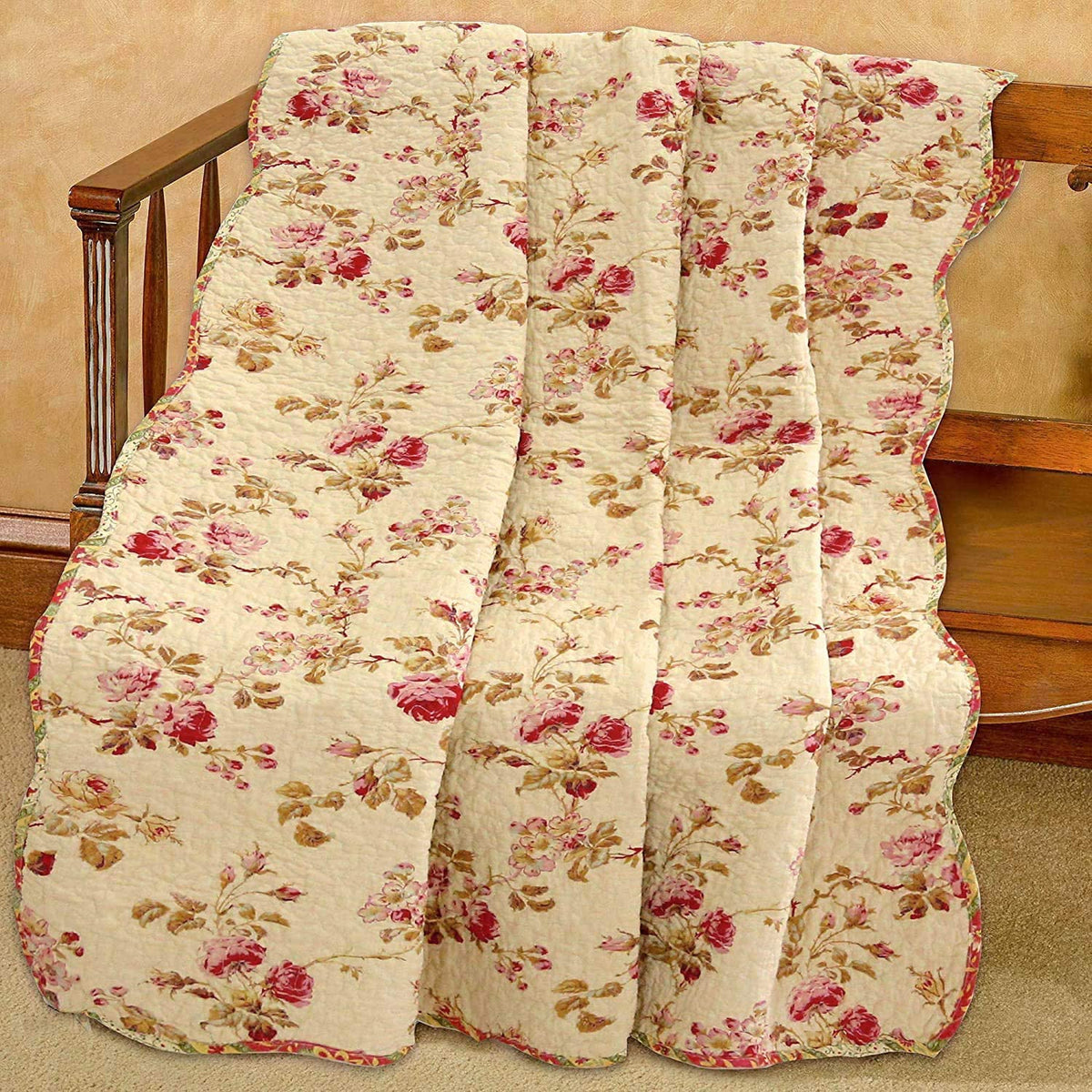 Floral quilt draped over a wooden chair on a beige carpet.