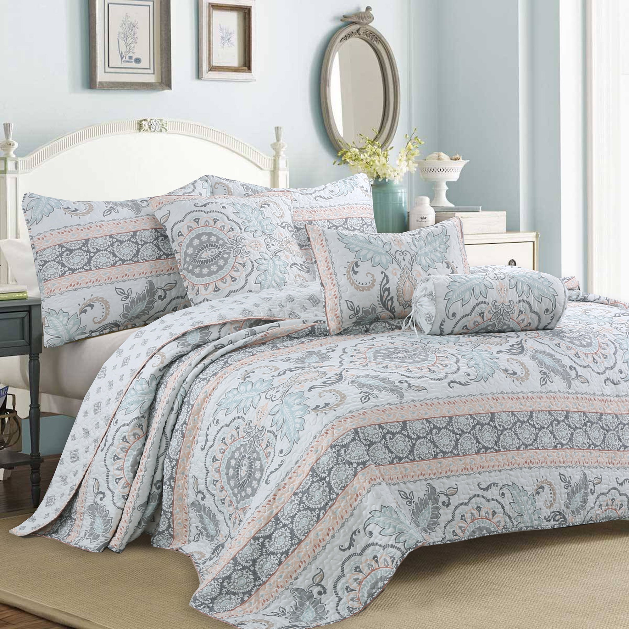 Peach paisley floral reversible quilt bedding set with aqua blue and grey accents on a farmhouse style bed.