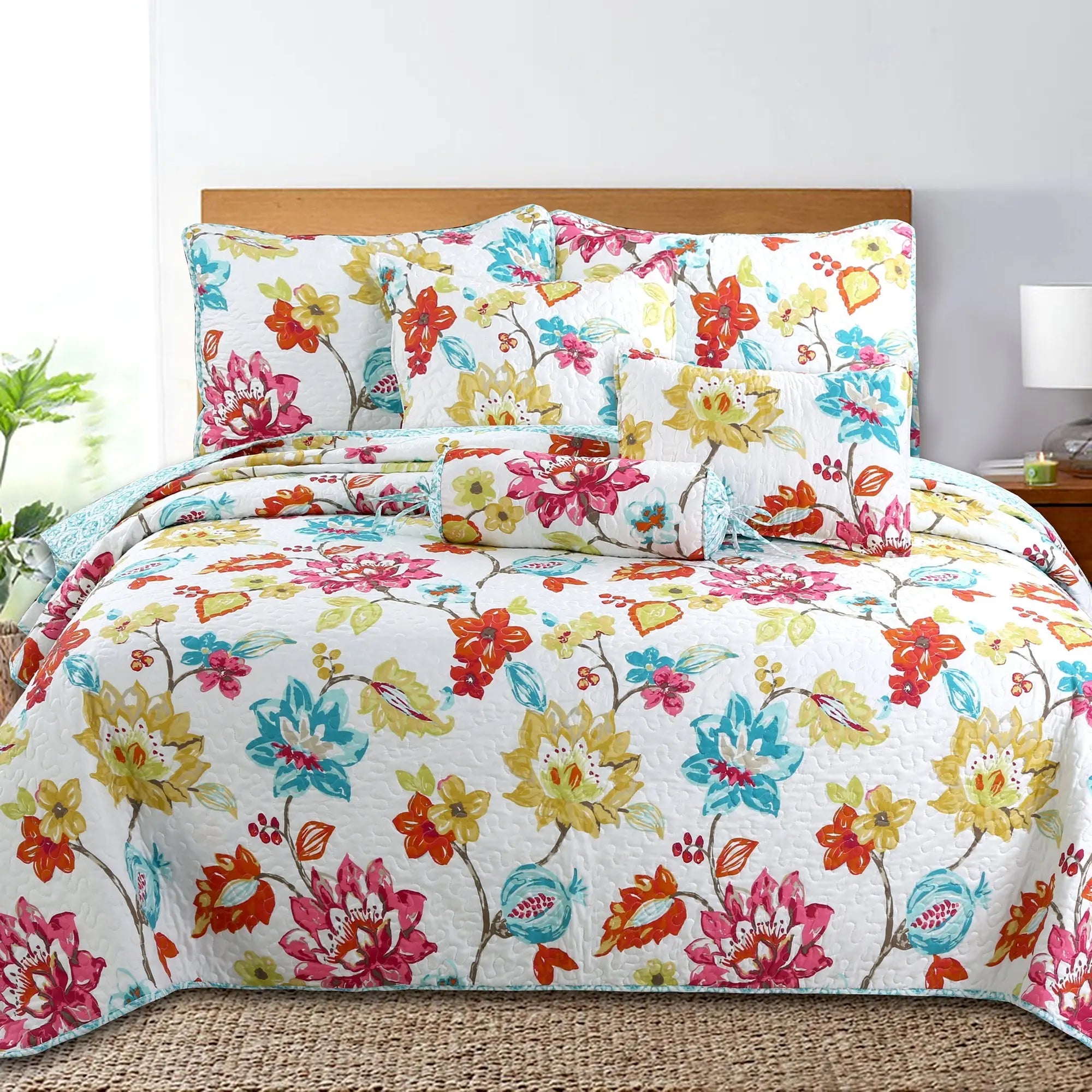 Tropical floral reversible quilt bedding set with colorful anemone garden print and matching shams for farmhouse, cottage, and coastal bedrooms.