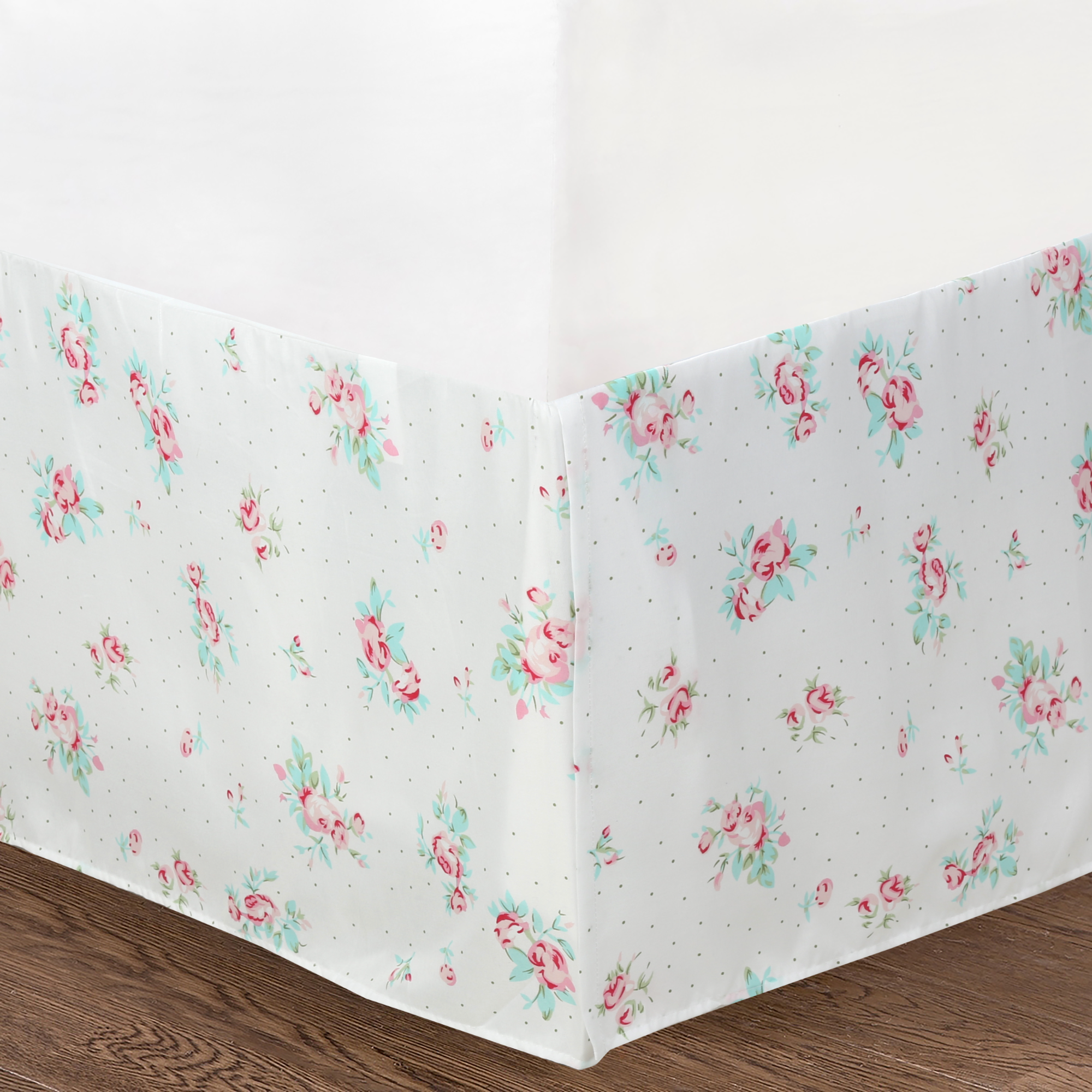 bedskirt of the Tiffany Pink Blossom floral patchwork reversible daybed bedding set with pink floral quilt, matching shams, bed skirt, and decorative throw pillows in a cozy cottage bedroom.