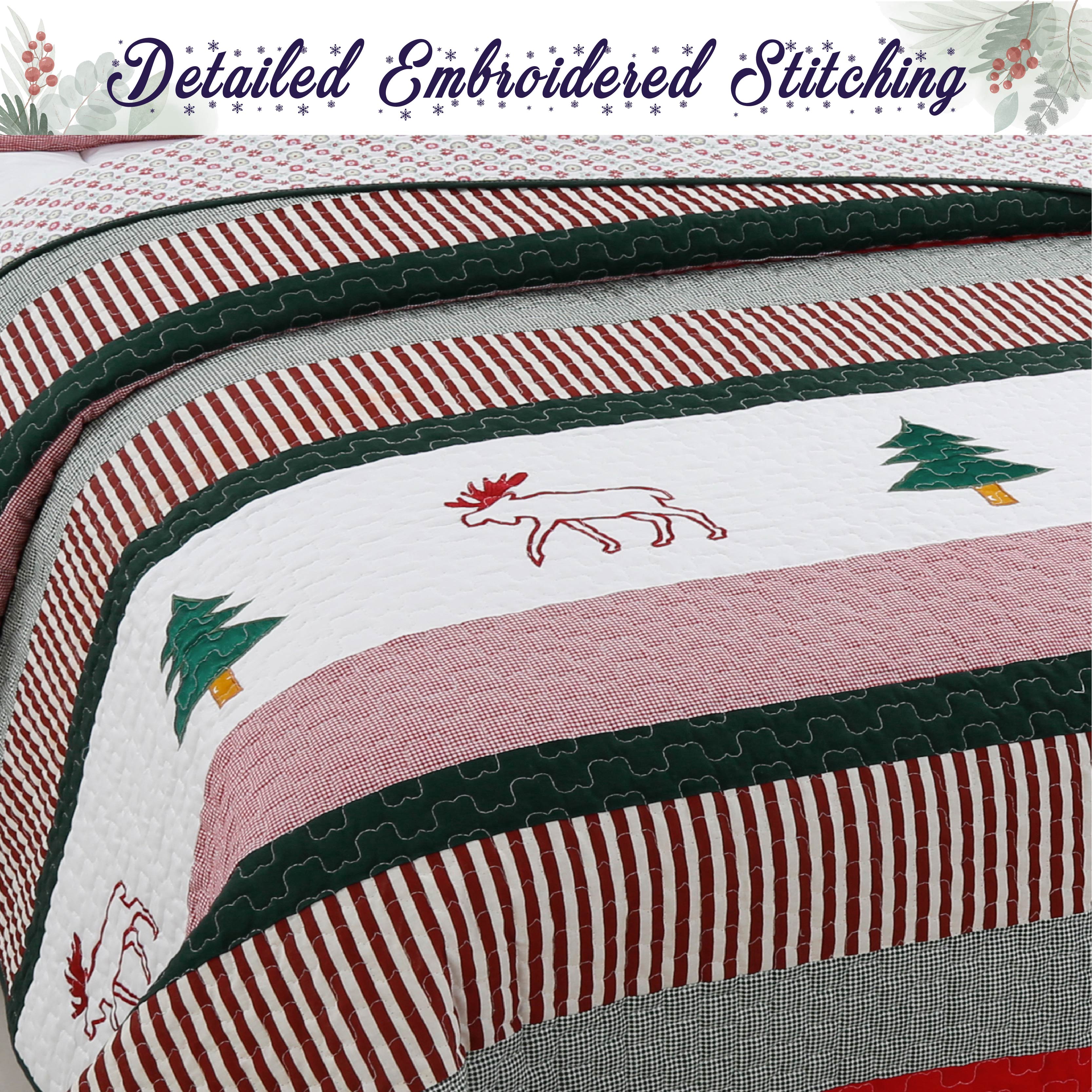 A close-up of a quilted blanket featuring red and white striped borders, a pink center band, green embroidered trees, and a red embroidered deer. A banner at the top reads 'Detailed Embroidered Stitching' with a floral border.