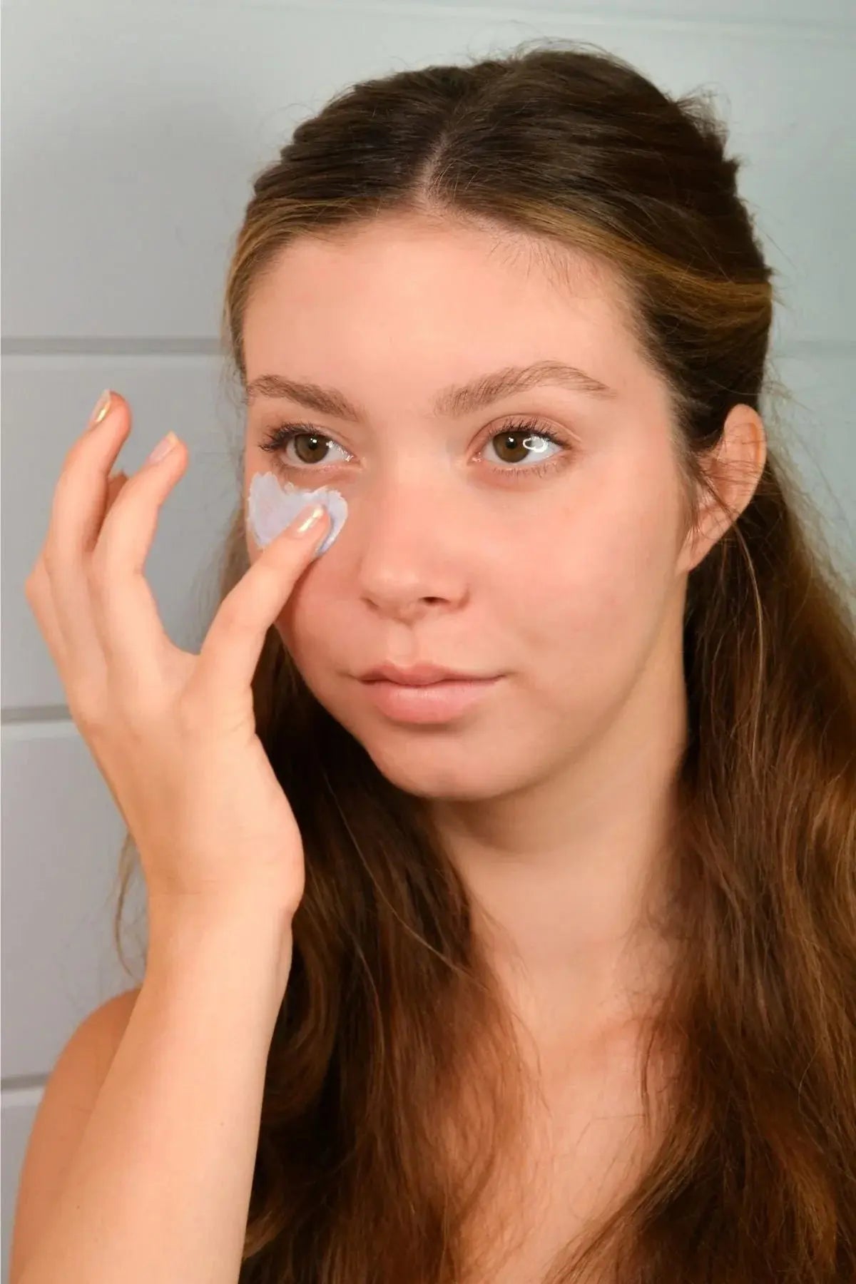Woman applying gentle eye cream for daily skincare routine