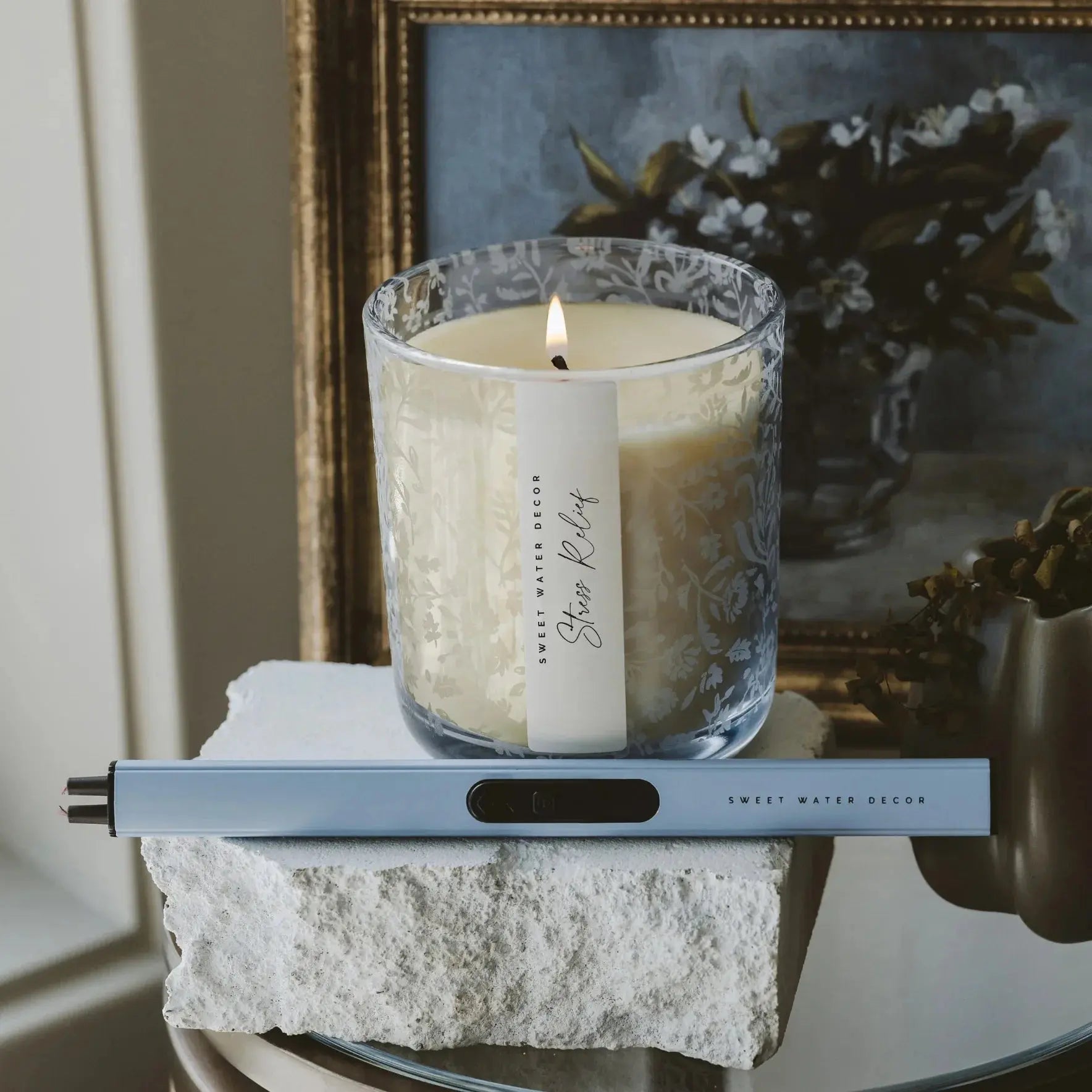 Lit Stress Relief candle in floral glass jar with lighter, cozy farmhouse decor