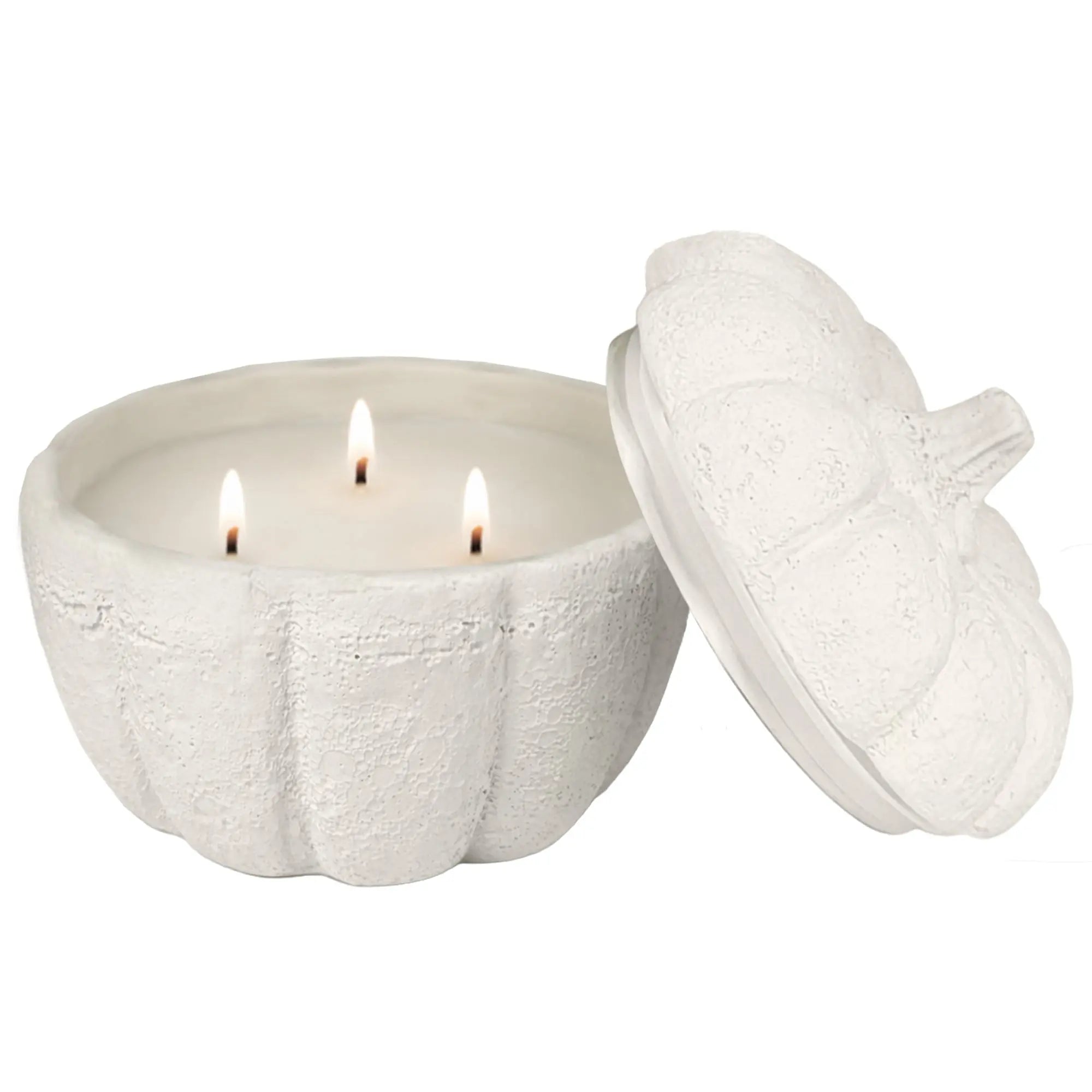 White pumpkin-shaped candle with a lid on a white background