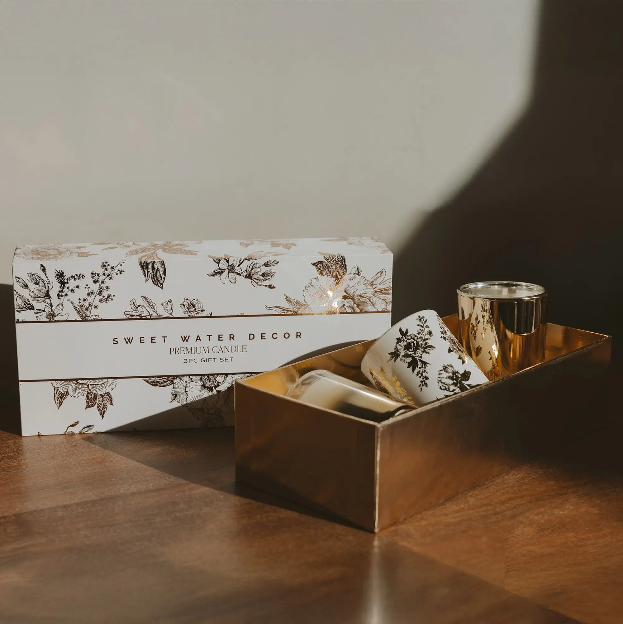 Sweet Water Decor candle set with packaging on a wooden surface