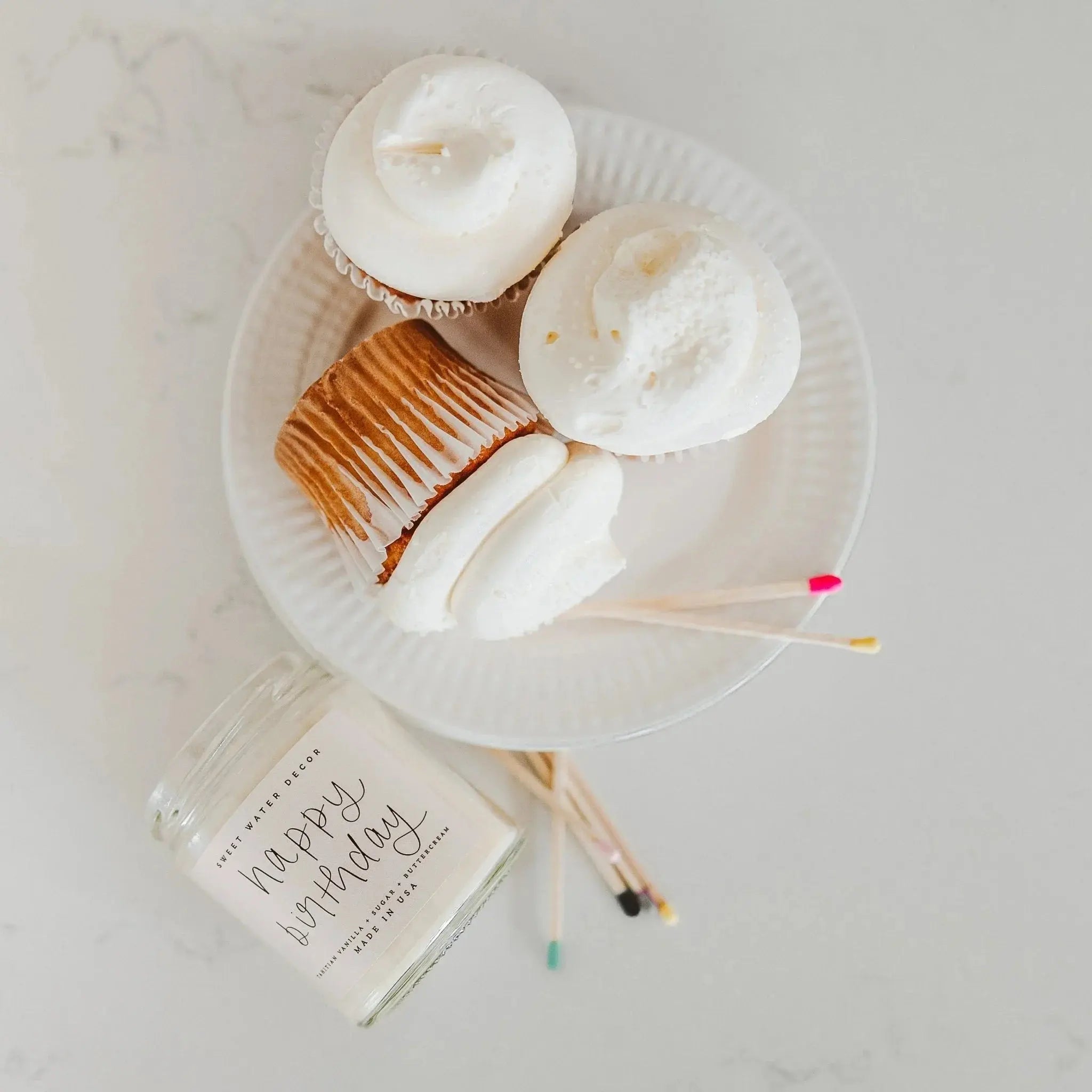Happy Birthday candle with vanilla sugar buttercream scent, cupcakes on white plate, cozy home decor