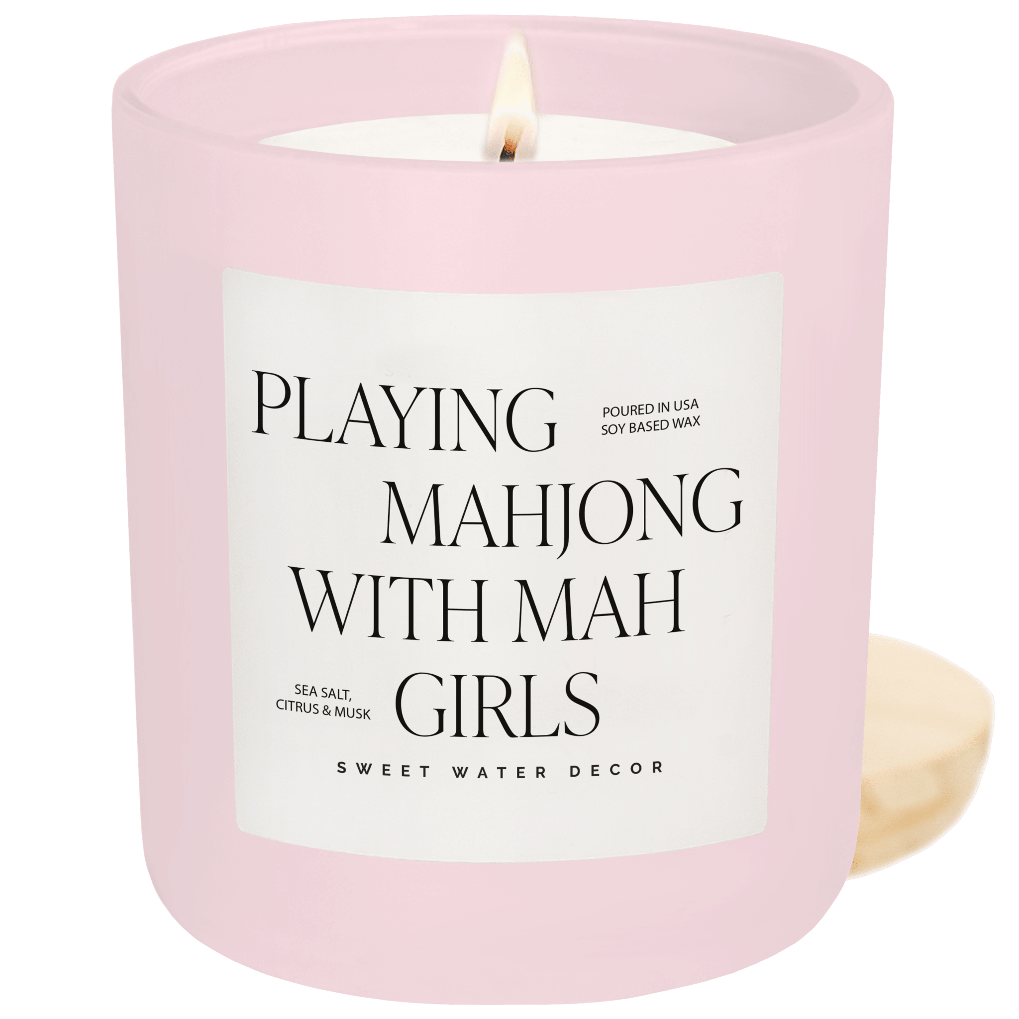 Pink candle with a label reading 'Playing Mahjong with Mah Girls' on a green background