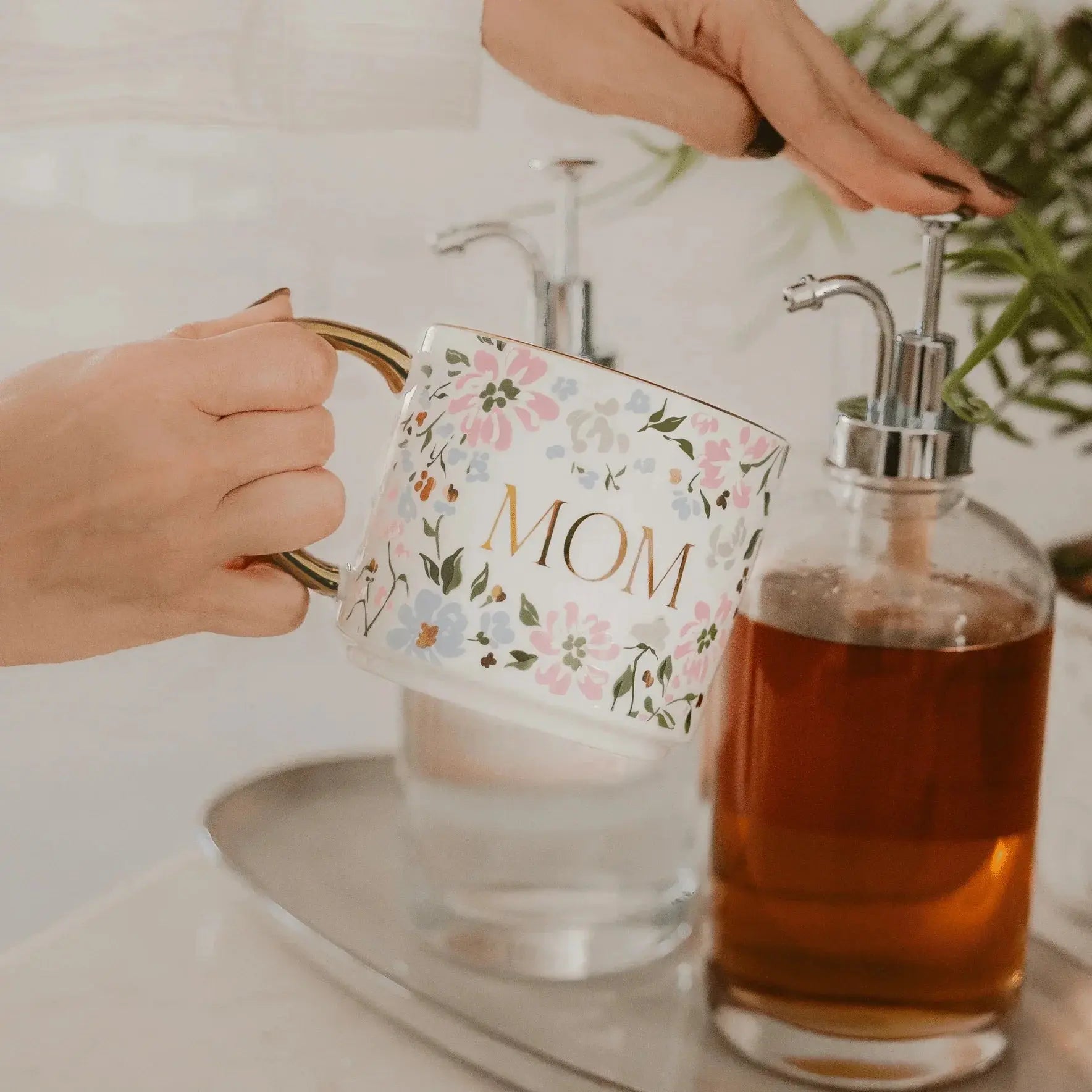 Floral 'MOM' mug with gold handle, cozy farmhouse decor, perfect for thoughtful gifts and warm home spaces