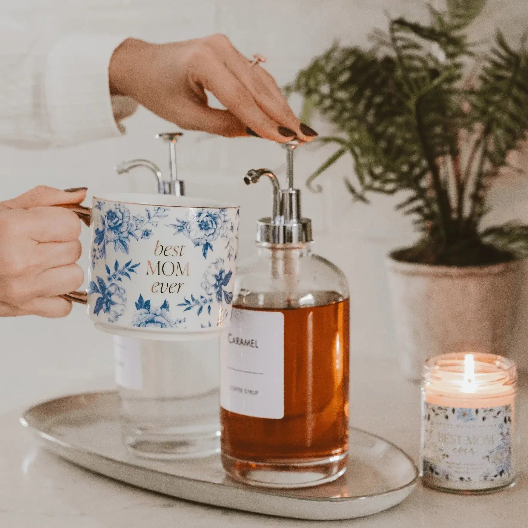 Best Mom Ever floral mug, caramel soap dispenser, and lit candle on tray for cozy home decor