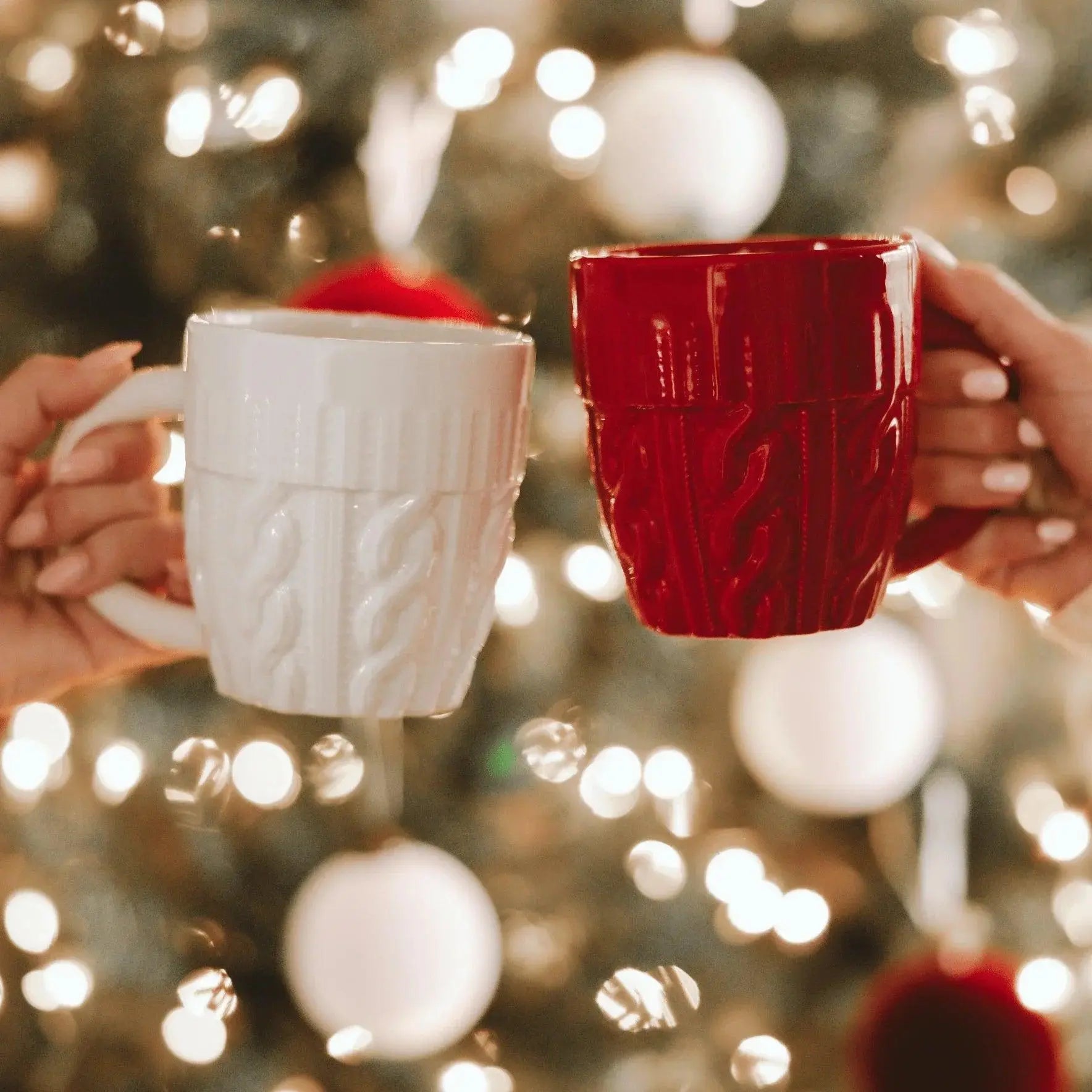 Cozy cable knit mugs in red and white, perfect for holiday drinks and farmhouse decor