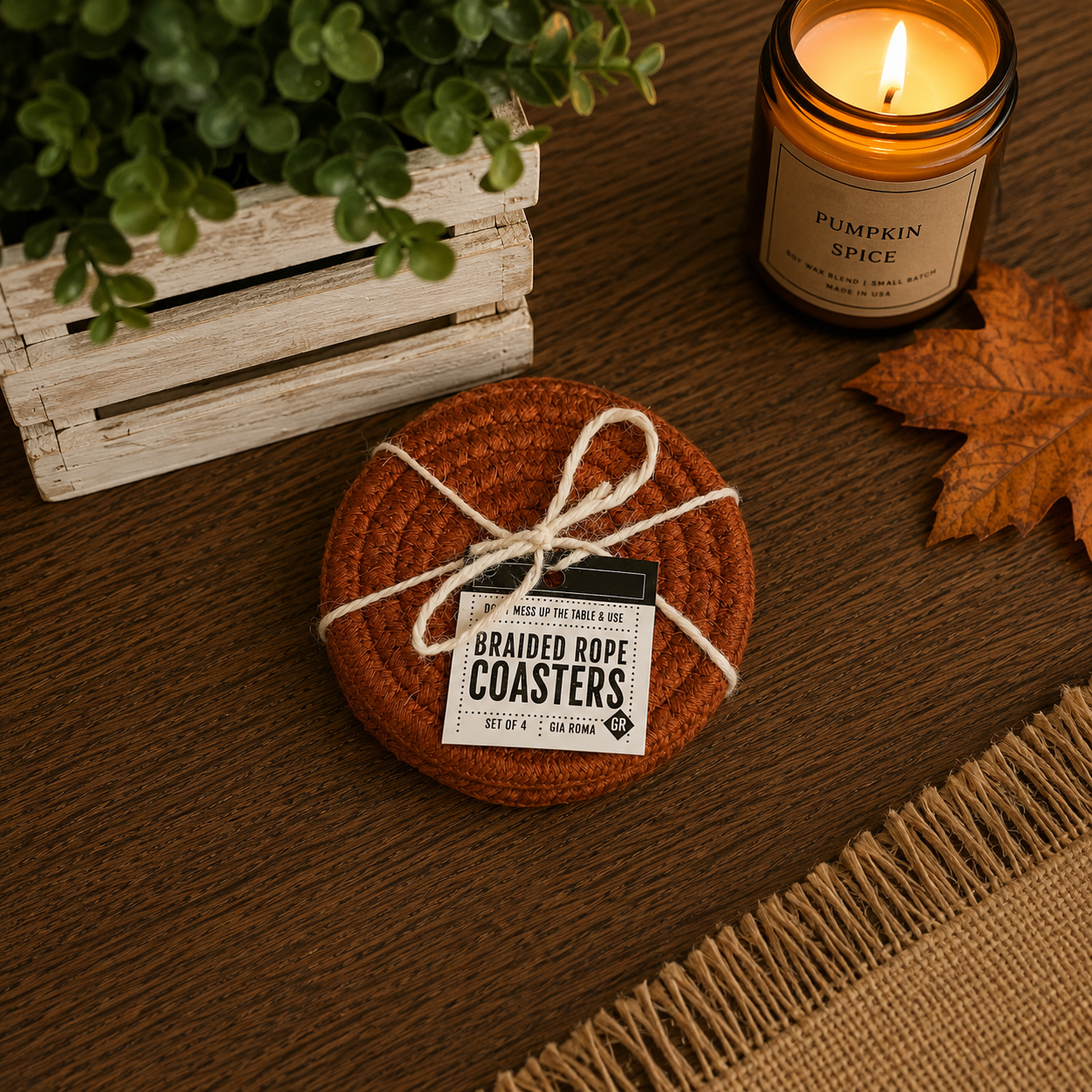 Braided rope coasters on a wooden surface with a candle and plant in the background