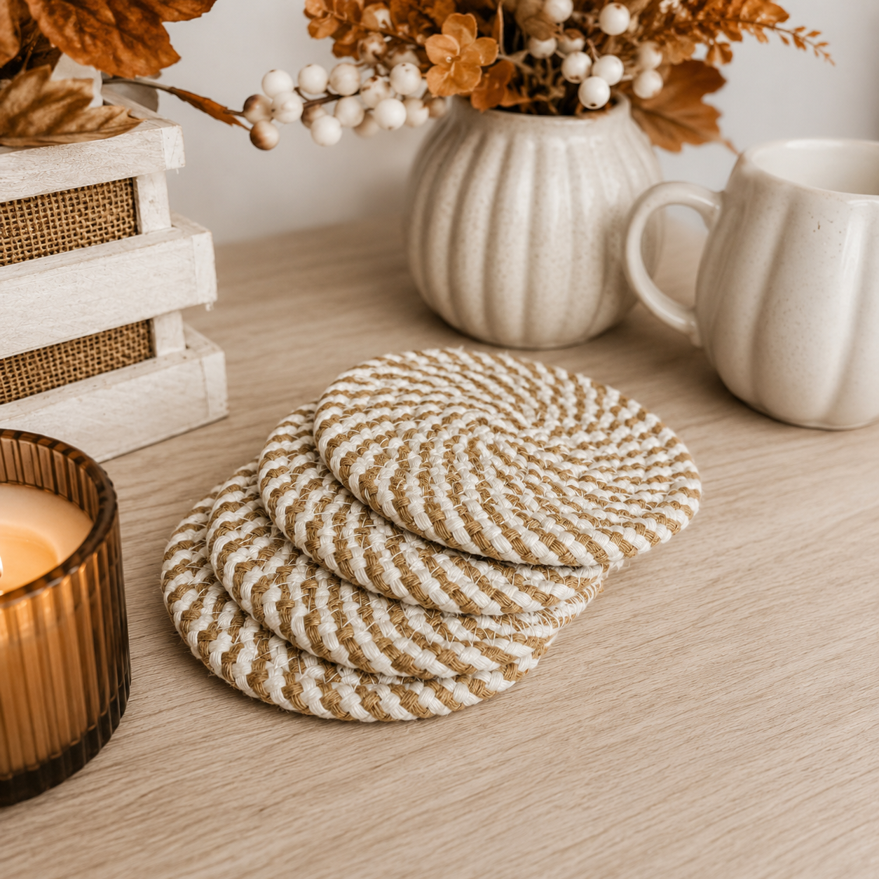 Set of round woven coasters on a wooden surface with decorative elements.