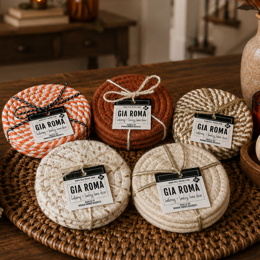 Five woven coasters with 'Gia Roma' labels on a wooden surface.