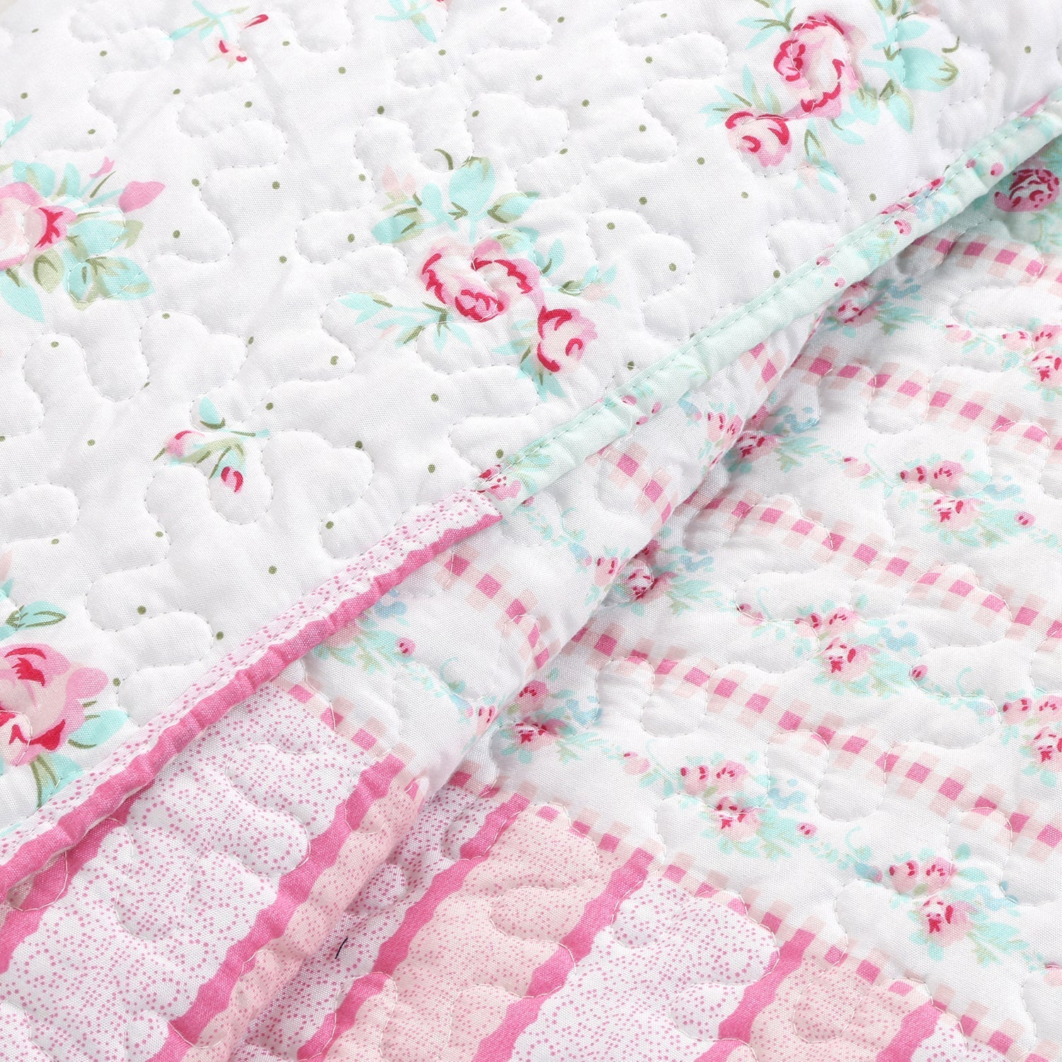 Tiffany Pink Blossom floral patchwork reversible daybed bedding set with pink floral quilt, matching shams, bed skirt, and decorative throw pillows in a cozy cottage bedroom.