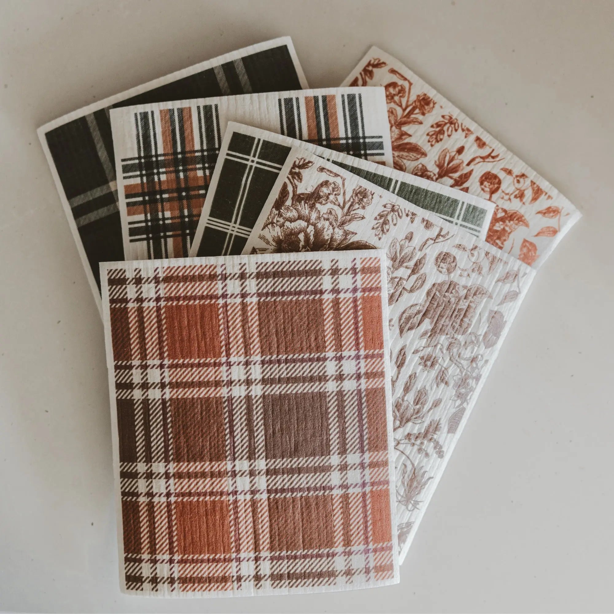 Set of patterned paper sheets on a light background