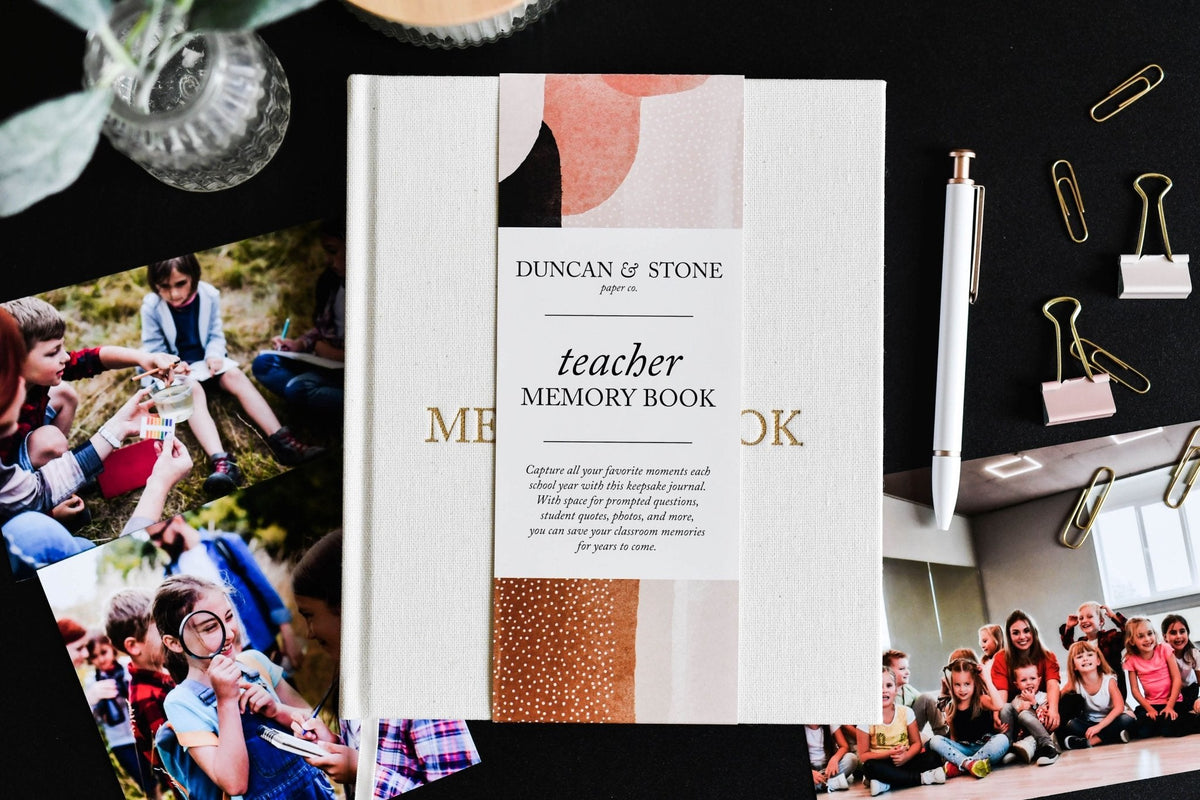 Teacher Memory Book by Duncan & Stone with photos of children on a black surface.
