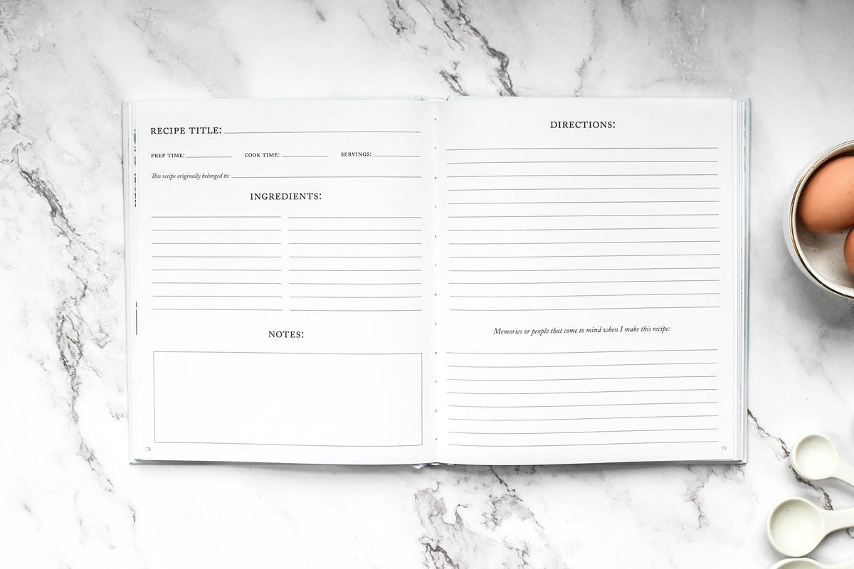 Blank recipe card on a marble surface with eggs and spoons in the background