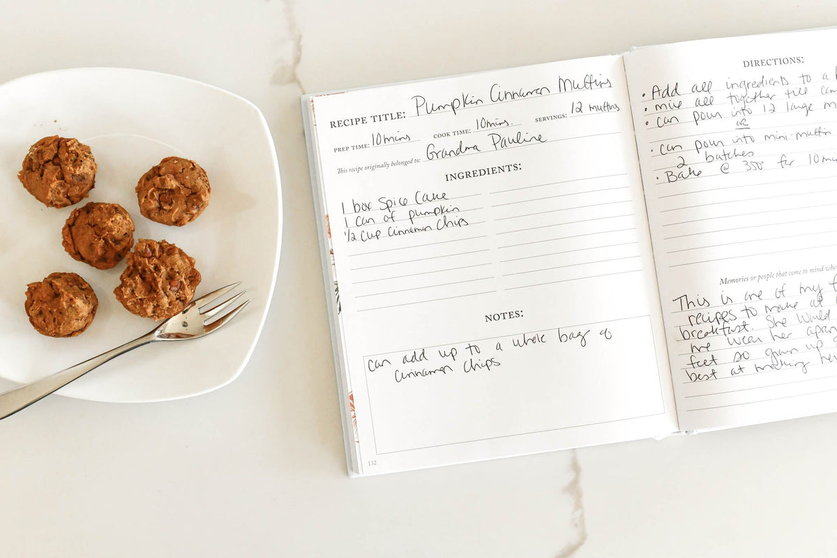 Recipe Journal with a Recipe for Pumpkin Cinnamon Muffins on a white marble counter with Pumpkin Cinnamon Muffins