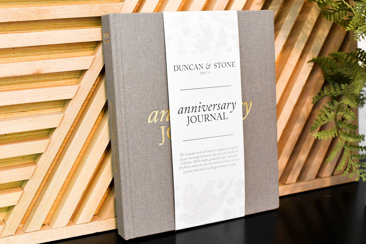 Duncan & Stone Anniversary Journal against a wood fence