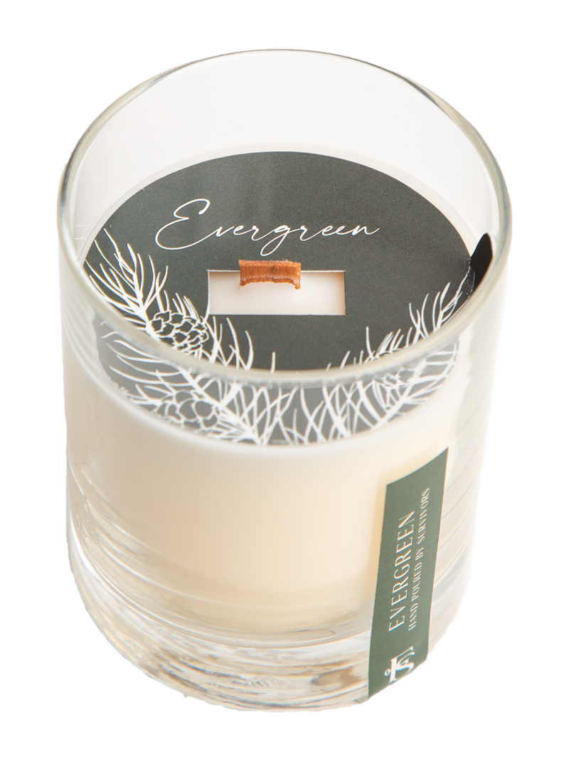 Candle in a glass jar with 'Evergreen' label on a white background