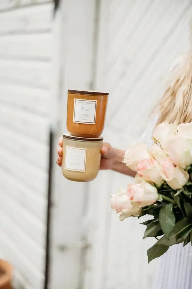 Cozy farmhouse candles with soft pink roses, perfect for warm, peaceful home decor and thoughtful gifts