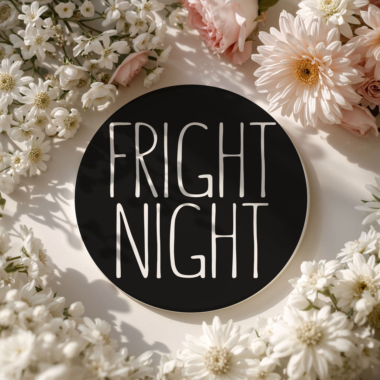 Floral arrangement with a black circle displaying 'Fright Night' text.