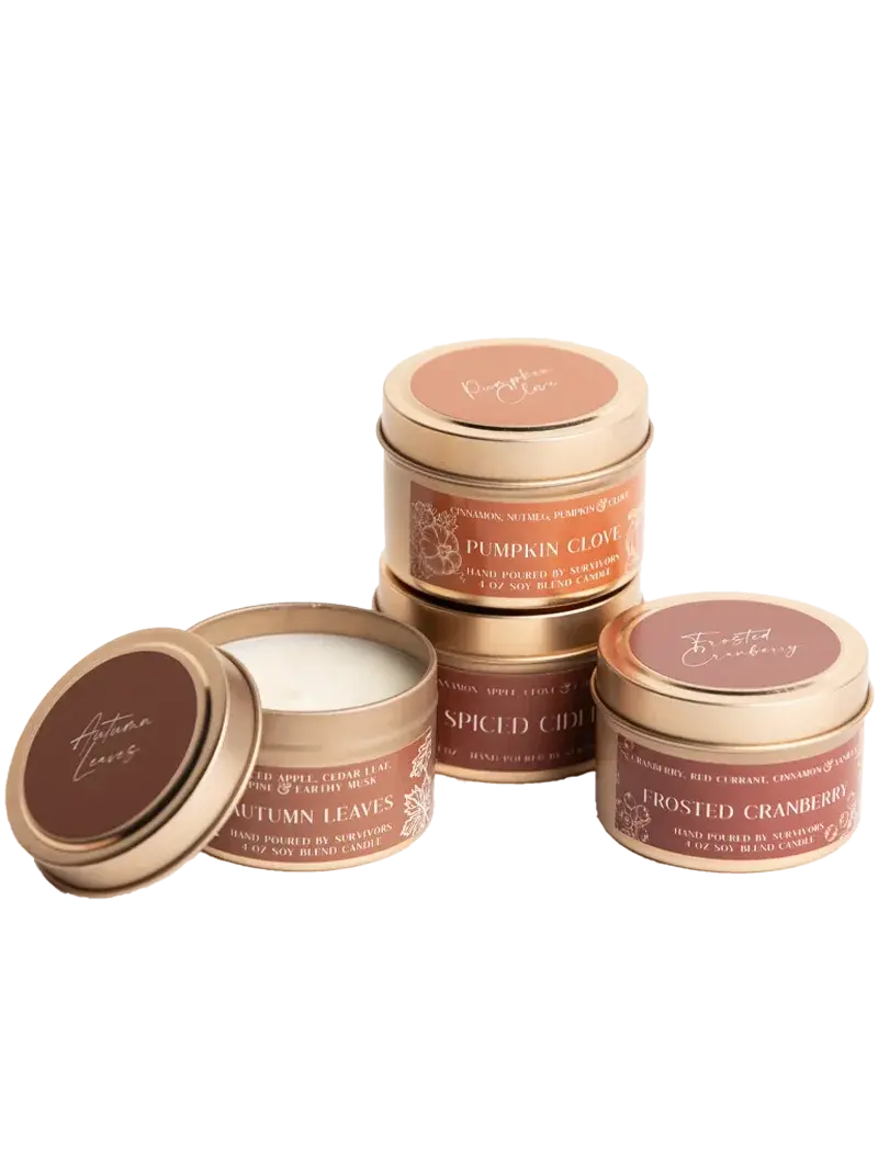 Cozy autumn soy candles in gold tins: Pumpkin Clove, Autumn Leaves, Frosted Cranberry, Spiced Cider