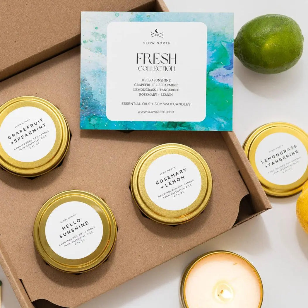 Fresh Collection soy wax candles in gold tins with citrus scents, perfect for cozy home decor