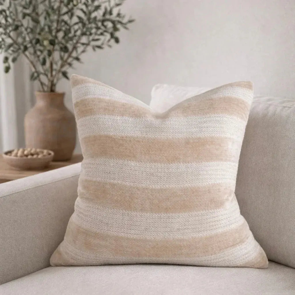 Beige and cream striped throw pillow on cozy sofa, farmhouse decor accent