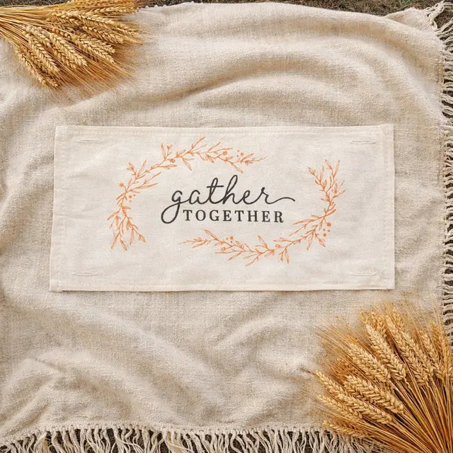 Fabric with 'gather together' text and wheat on a textured fabric background