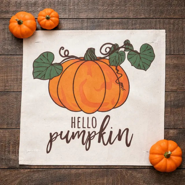 Decorative sign with pumpkins and 'Hello Pumpkin' text on a wooden surface