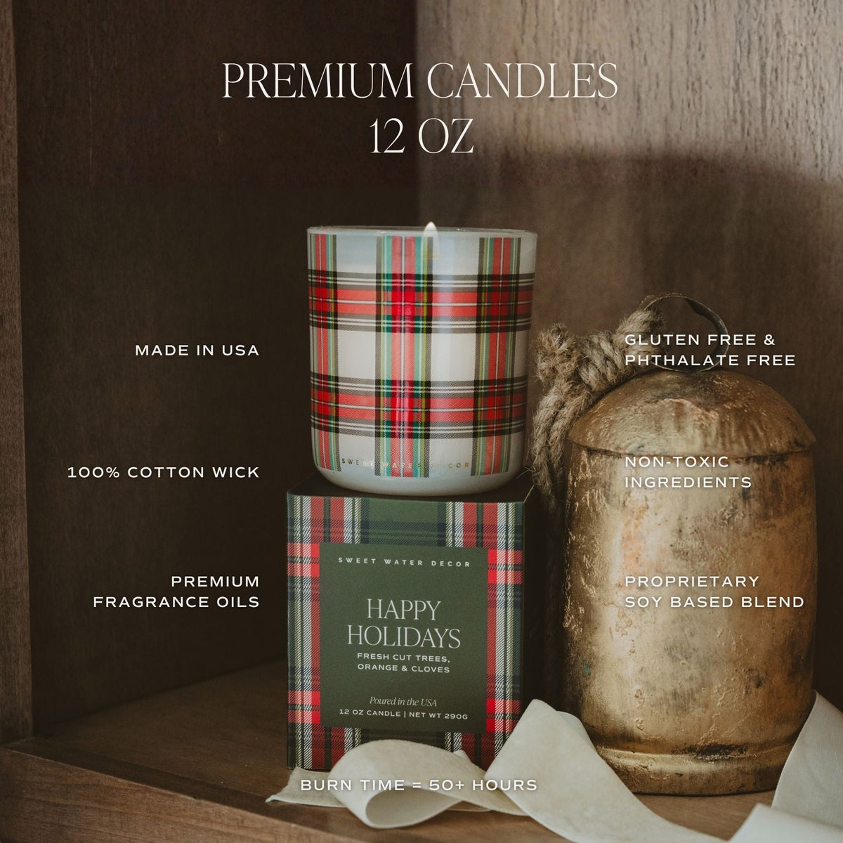 A 12 oz premium candle set from Sweet Water Brand, featuring a white candle with a red, green, and black plaid pattern, its matching plaid box labeled 'Happy Holidays', and a rustic metal container with twine, set against a dark wood background with product feature text overlays.