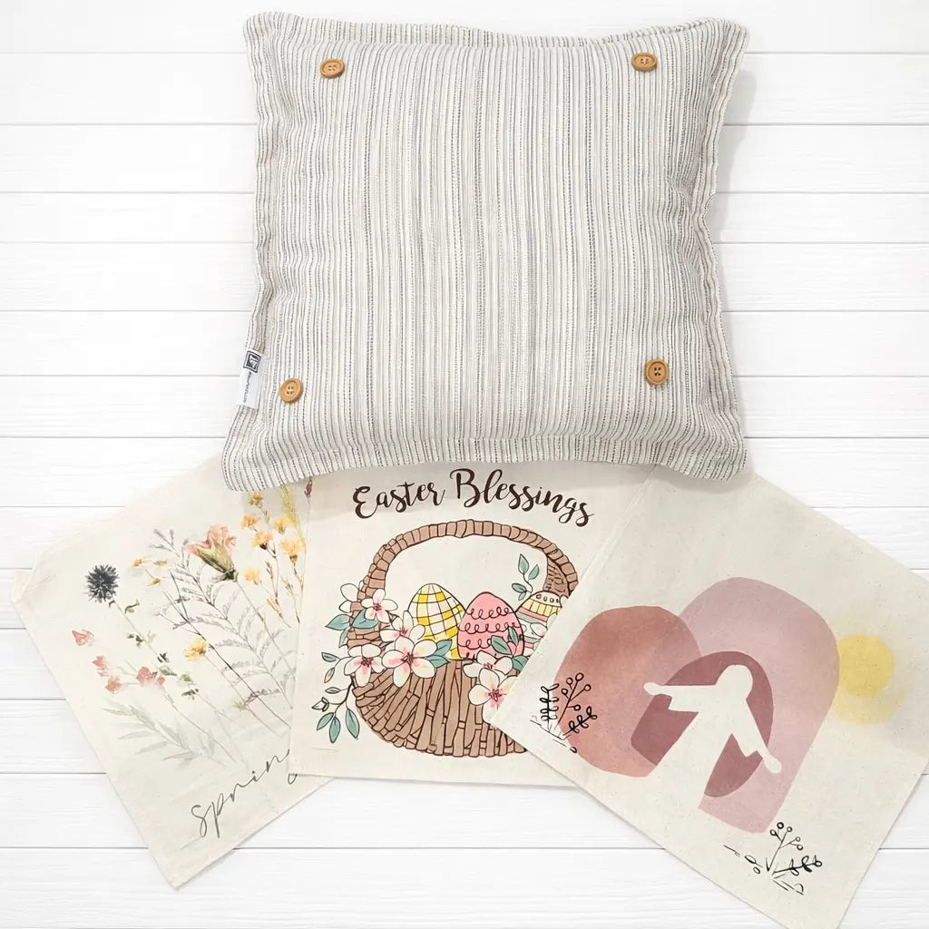 Decorative pillow with 'Easter Blessings' card and heart-shaped card on a wooden surface