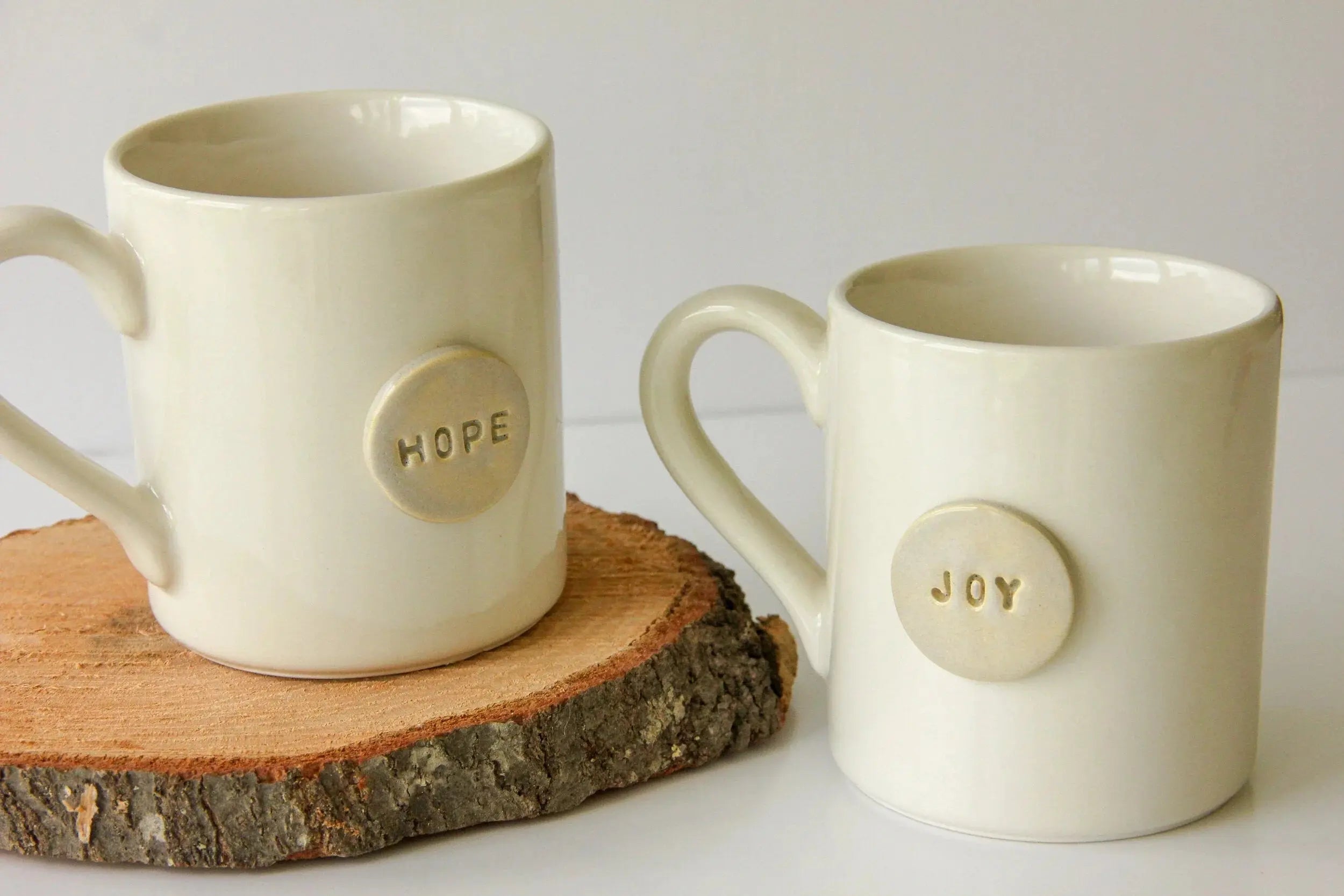 Hope and Joy ceramic mugs on wood slice, cozy farmhouse home decor