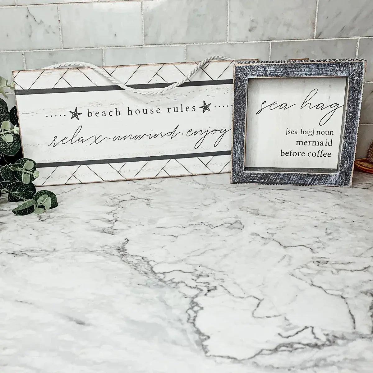 Beach house rules and sea hag decor signs on marble countertop for cozy cottage style home