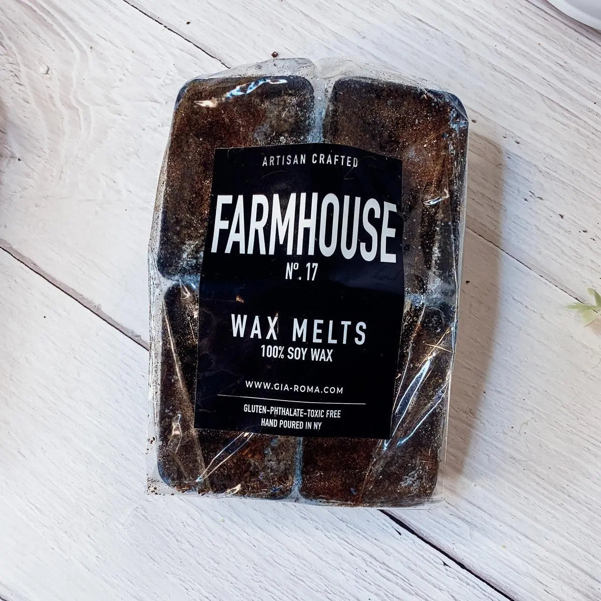 Packaged wax melts labeled 'Farmhouse' on a wooden surface