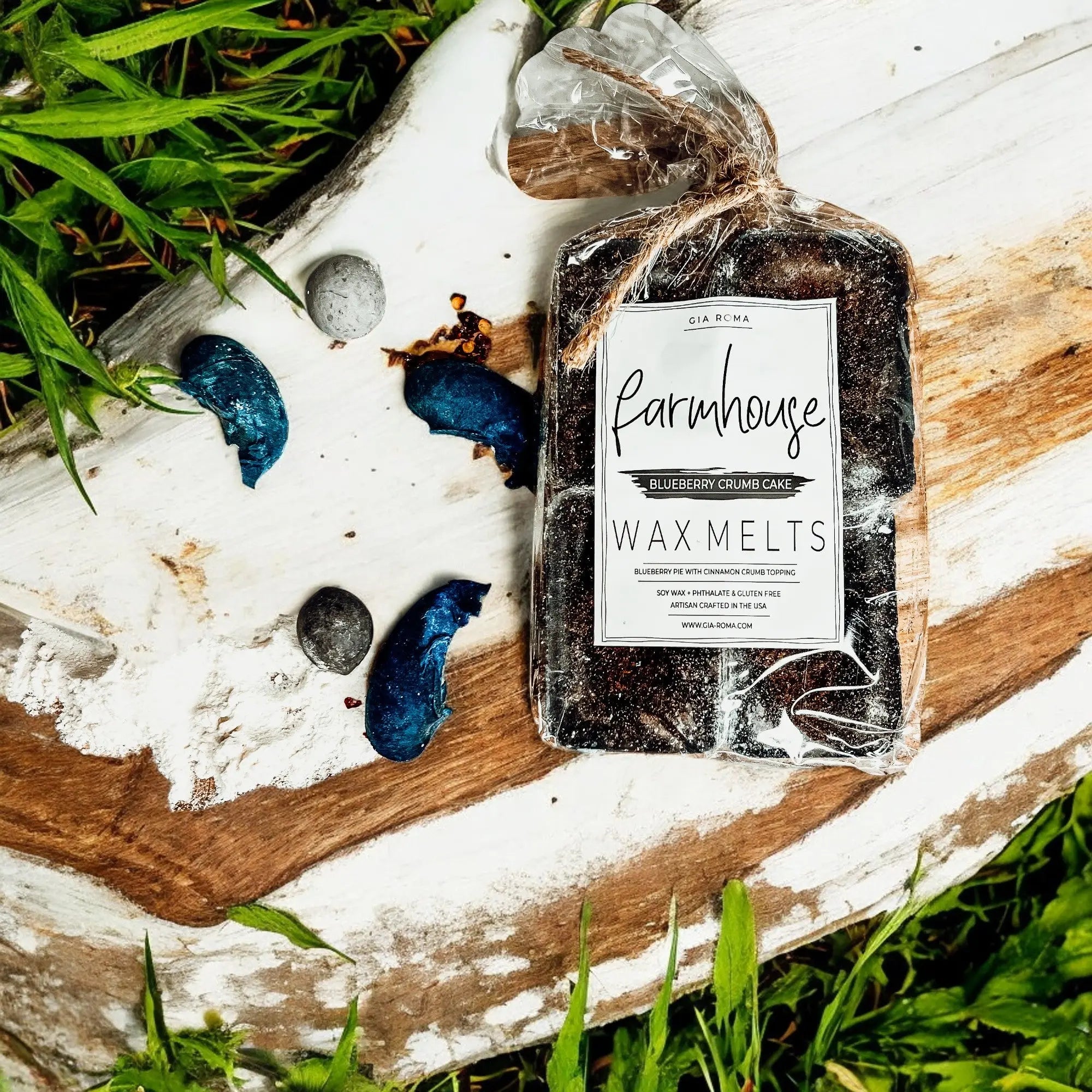 Pack of Farmhouse Wax Melts on a wooden surface with grass in the background