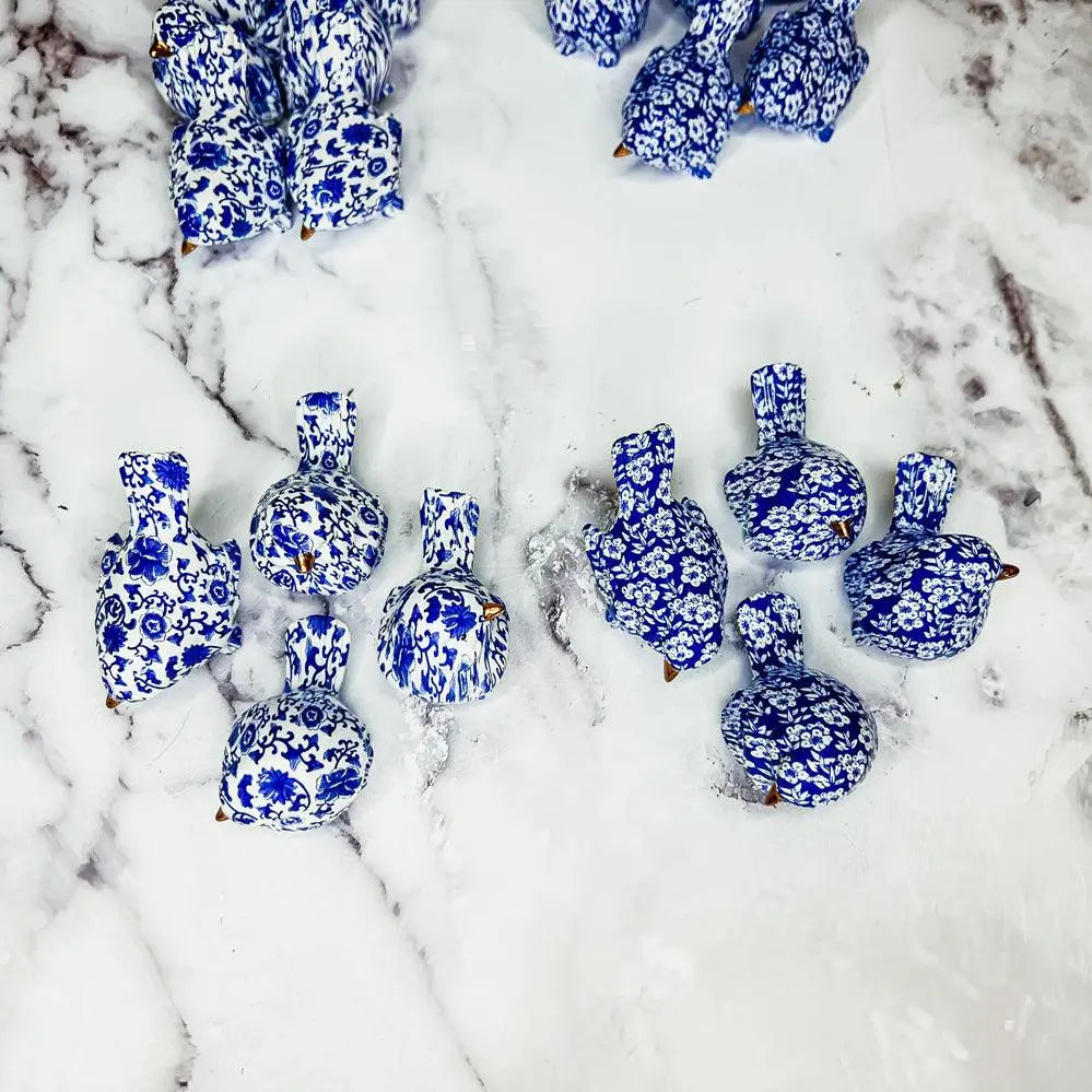 Decorative blue and white ceramic ducks on a snowy surface