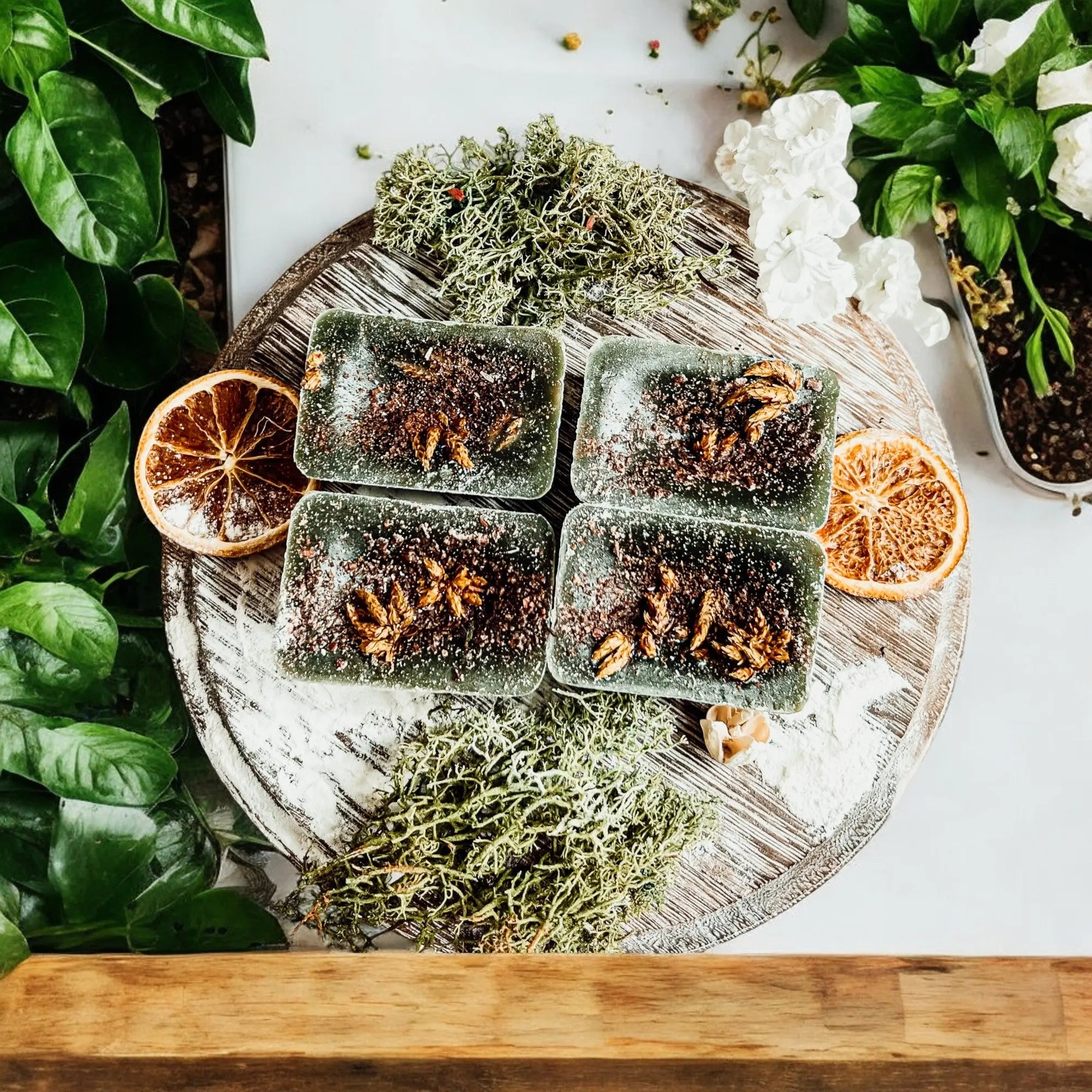 Herbal tea cubes on a wooden board with decorative elements