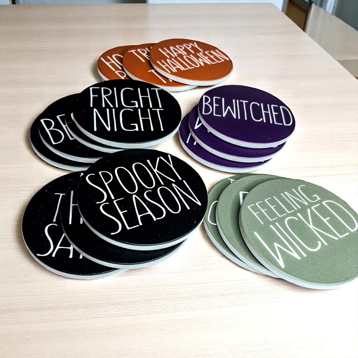 Set of Halloween-themed coasters on a wooden surface