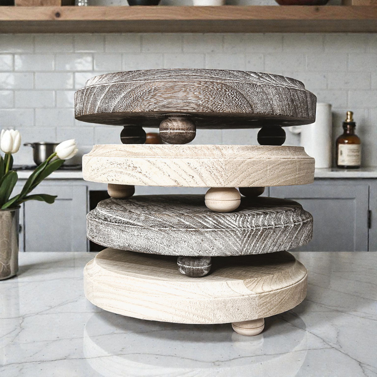Wooden tiered stand on a kitchen counter with a neutral color scheme.