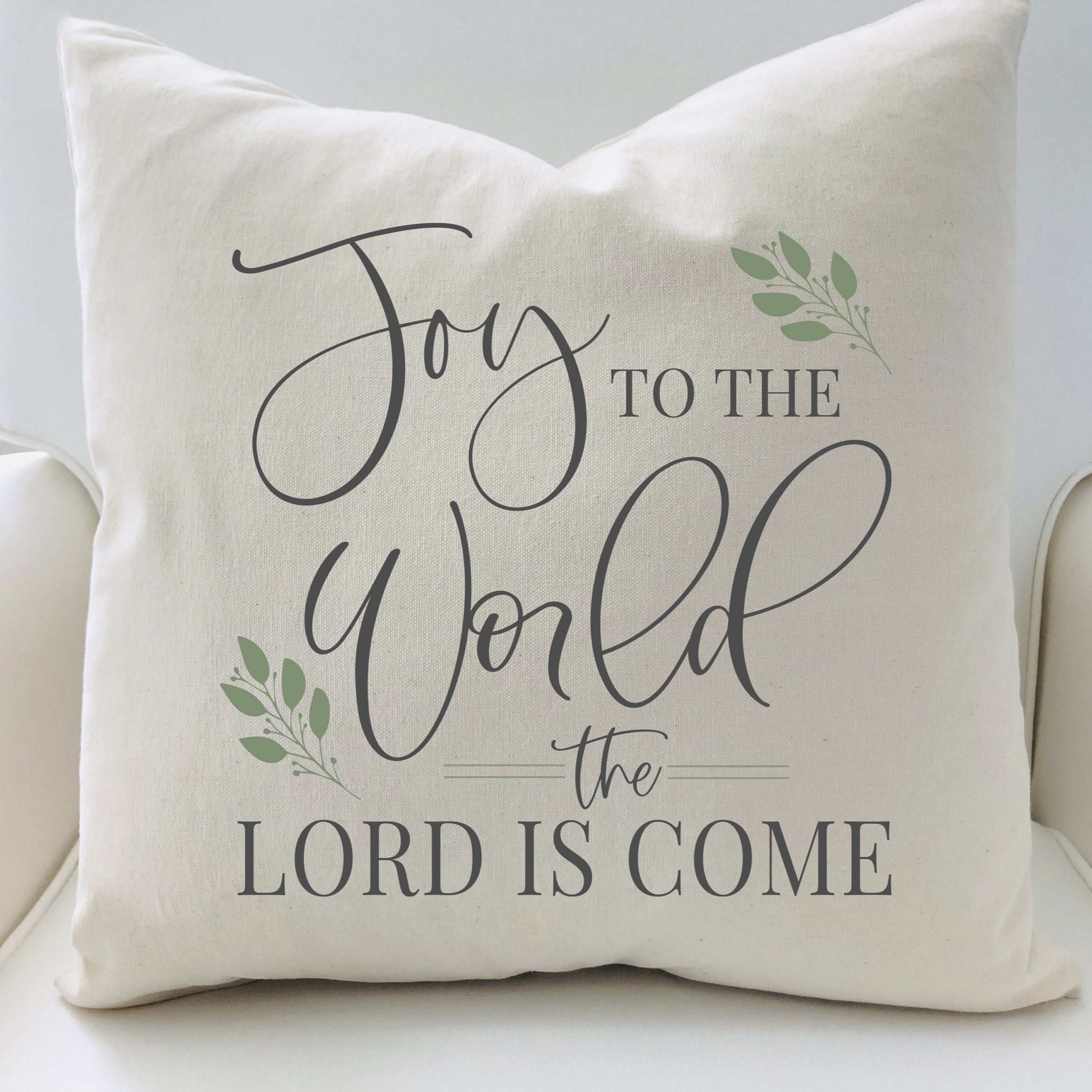 Decorative pillow with 'Joy to the World the Lord is Come' text on a white background