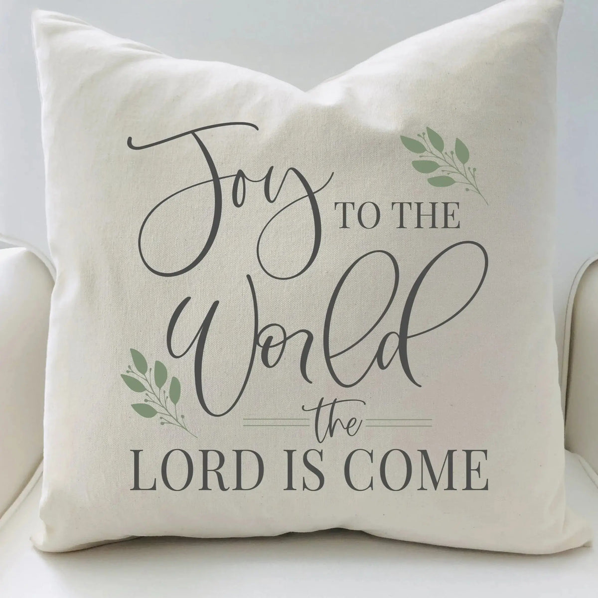 Decorative pillow with 'Joy to the World the Lord is Come' text on a white background