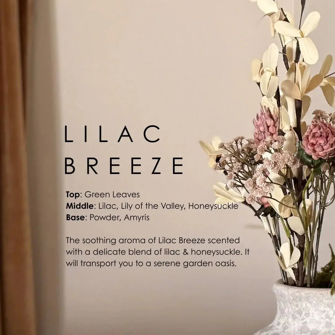 Lilac Breeze scented candle with dried floral arrangement in farmhouse vase, cozy cottage decor