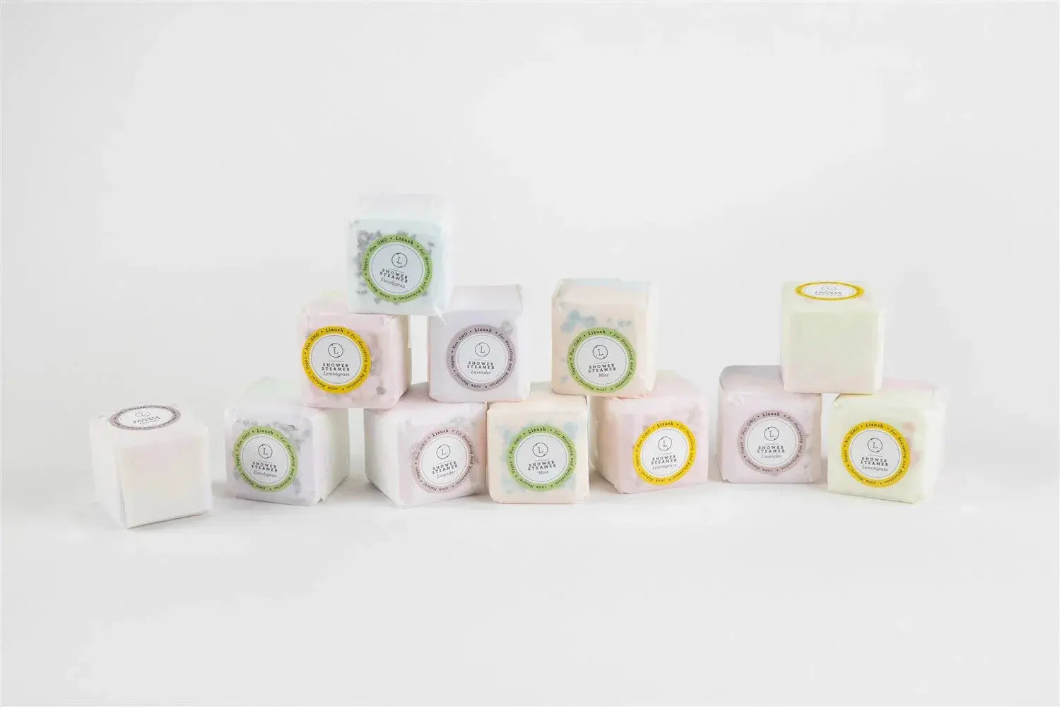 Assorted shower steamers in pastel cubes with lavender, eucalyptus, and mint scents for cozy bath essentials