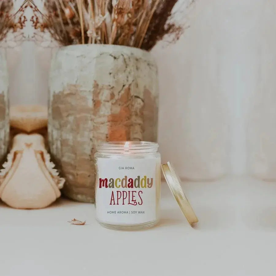 Candle labeled 'comfy & cozy' with decorative items in the background