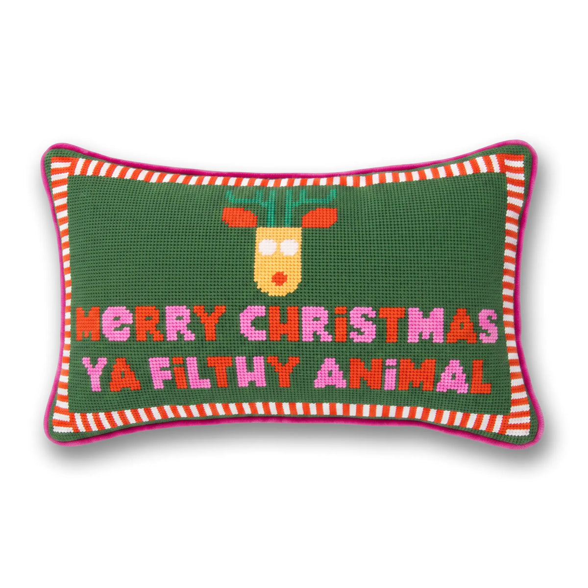 A rectangular needlepoint pillow with a dark green background, featuring a pixelated reindeer head and the text 'MERRY CHRISTMAS YA FILTHY ANIMAL' in pink, orange, and white. The pillow has a pink and white striped border and is shown on a white background with a soft drop shadow.