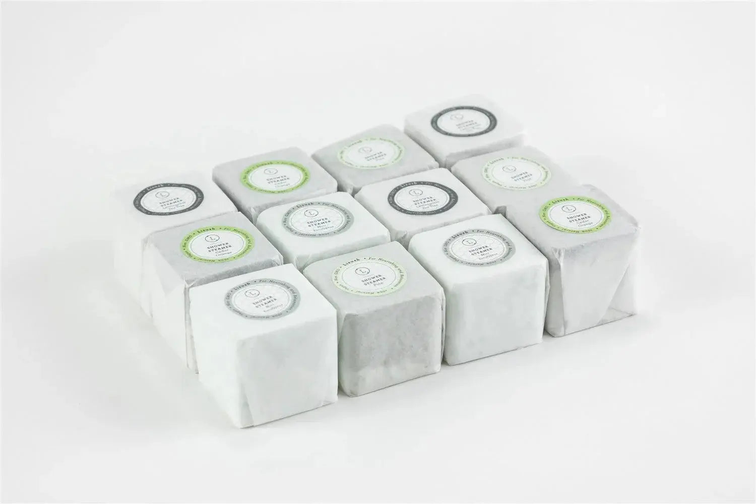 Assorted shower steamers in white packaging, perfect for bath essentials and cozy home spa relaxation